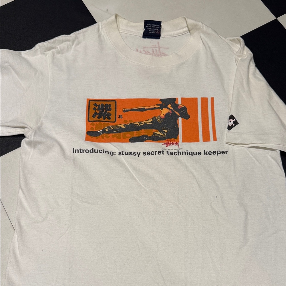 Stussy Secret Technique White T-Shirt with Orange Graphic